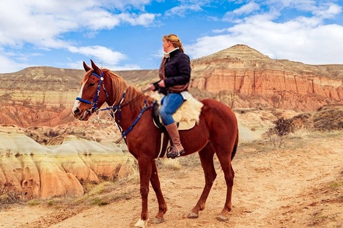 Horse Riding in Cappadocia in fairy chimeys - Sunset Point Photo Pause for Golden Hour
